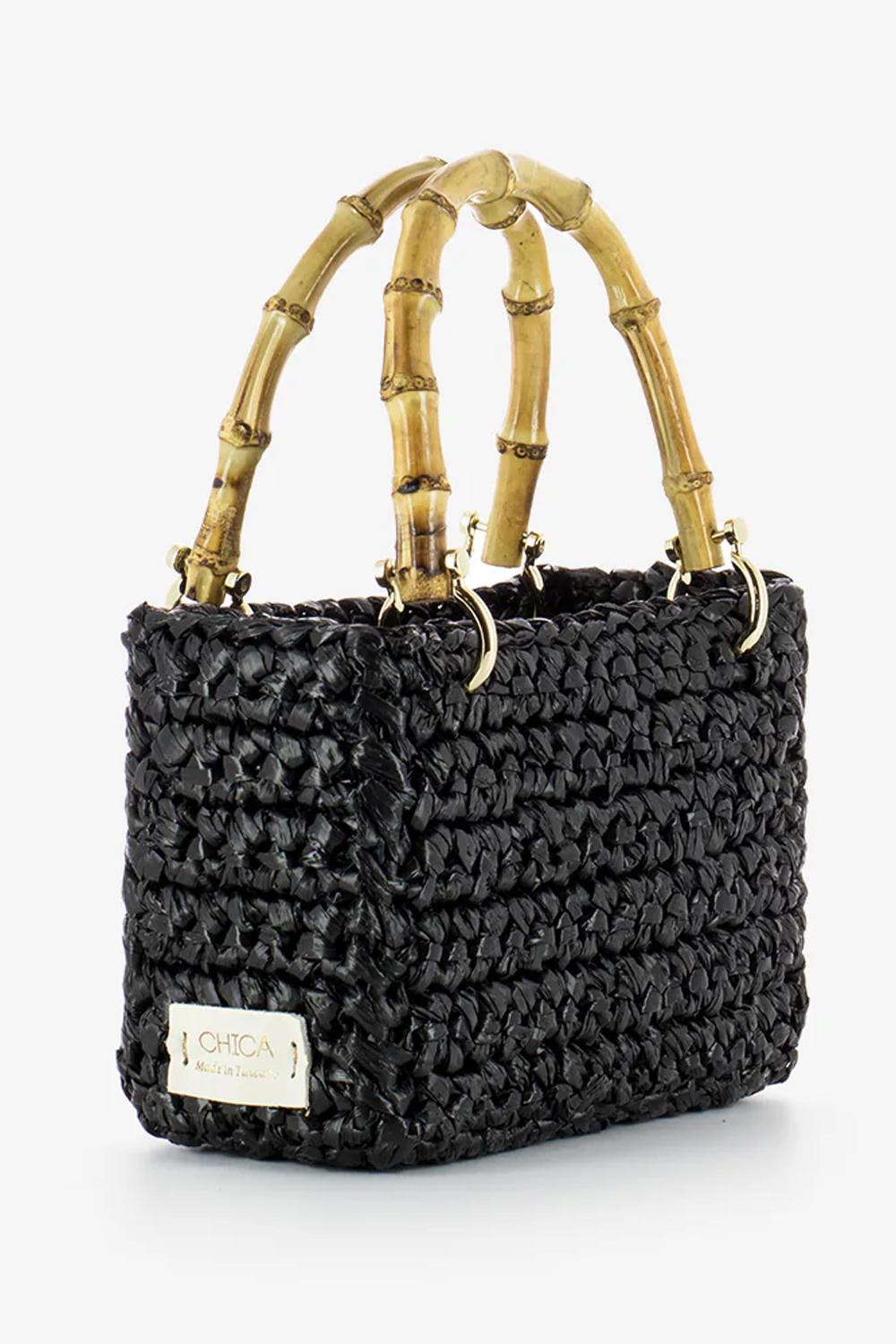 mini bag in woven raffia rectangular shape, two shiny bamboo handles and gold metal hooks with shoulder strap